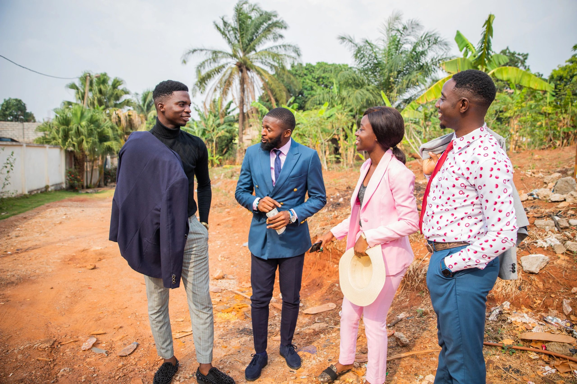 Four young Ghanaian professionals in conversation on a development site